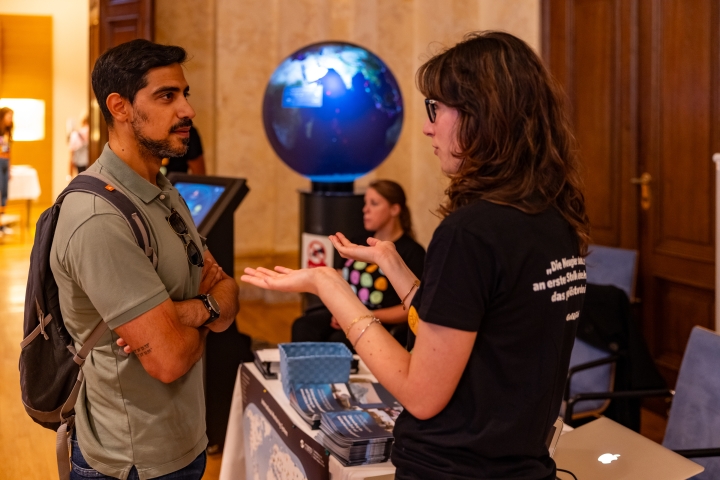 Visitor speaking to CTBTO intern, Chiara Cogliati 